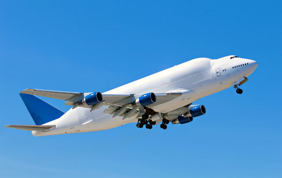 a cargo airplane flying in the blue sky